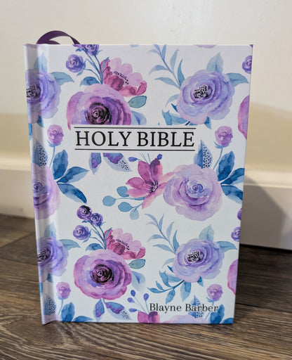 Floral-patterned Bible on a wooden surface