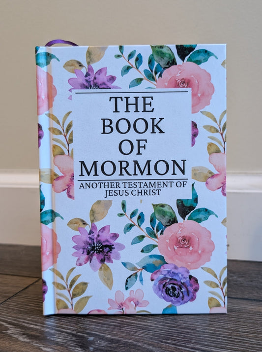 Book of Mormon with floral design on a wooden surface
