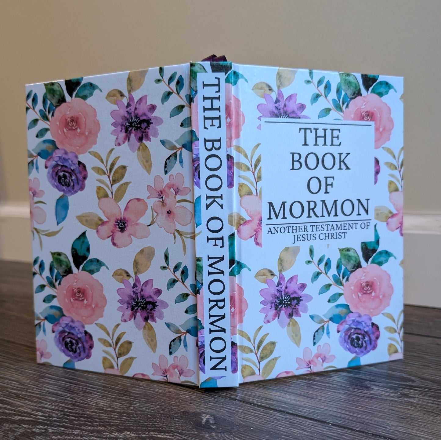 Floral-covered 'The Book of Mormon' on a wooden surface