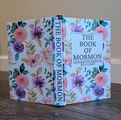 Floral-covered 'The Book of Mormon' on a wooden surface