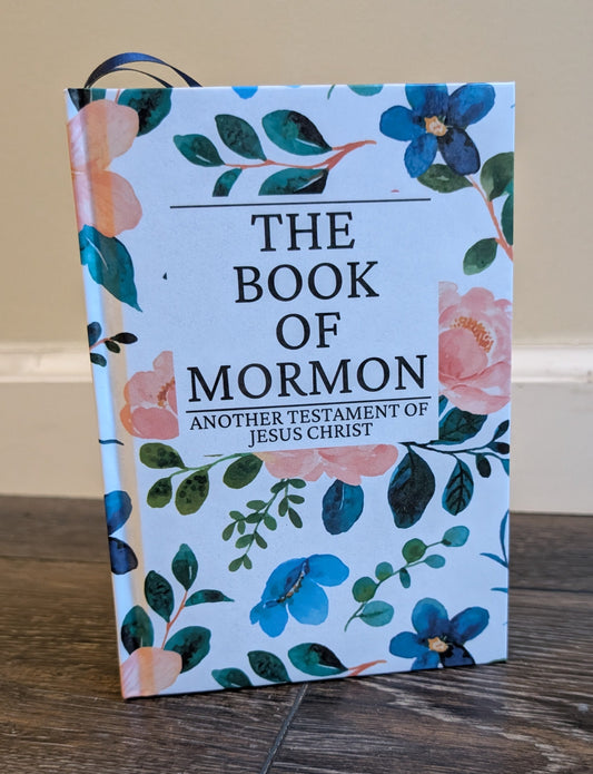 Book of Mormon with floral design on a wooden surface