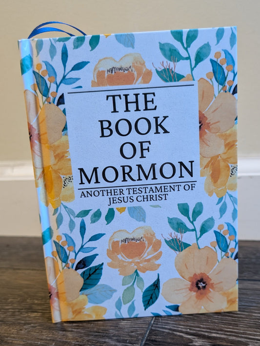 Book of Mormon with floral design on a wooden surface