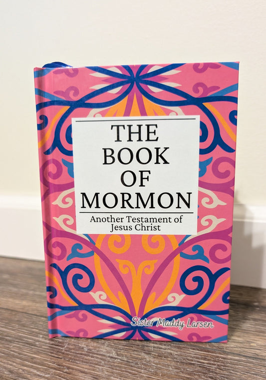 Book of Mormon with colorful cover on a wooden surface