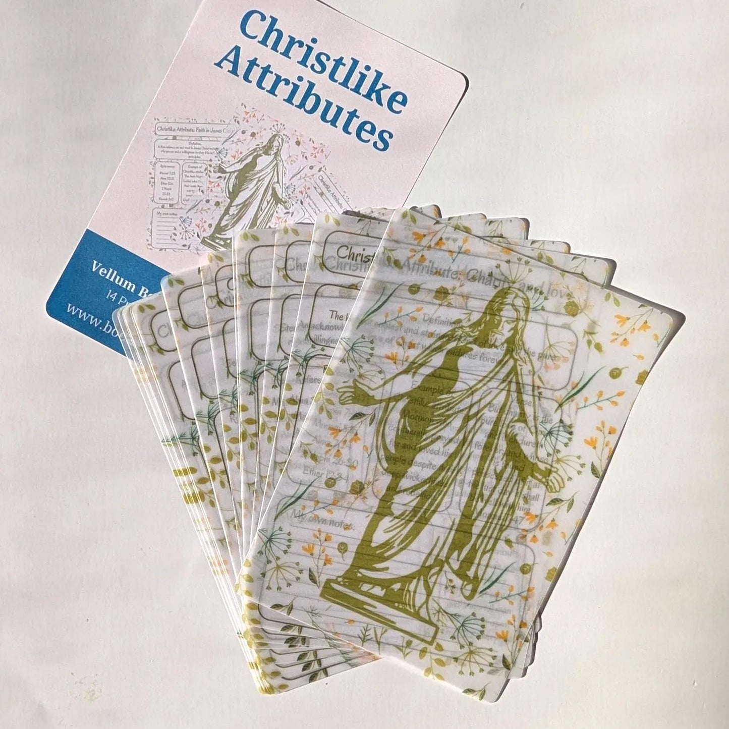 A fanned deck of Christlike Attributes vellum sheets written with green ink.